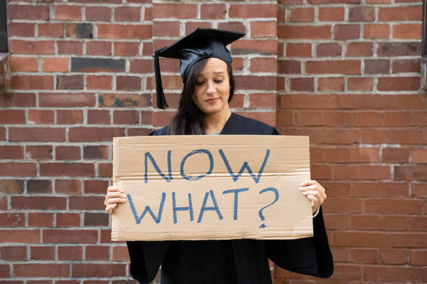 istock Sad Graduate Student Standing With Now What Placard 1184225760