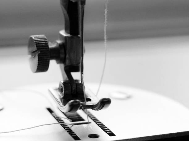 istock sewing machine and item of clothing macro 1184225866