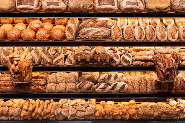 Bakery shelf with many types of bread. Tasty german bread loaves on the shelves_ stock photo