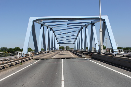 the swing bridge over the canal of ghent to terneuzen in zeeland, holland in summer and a blue sky in the background