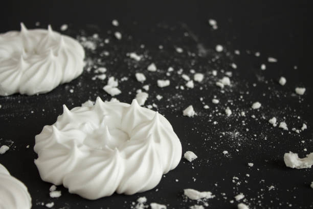 istock White meringue with crumbs on a black background 1184227578