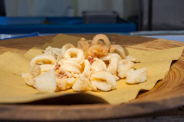 Close up of calamari rings, fried food on tray