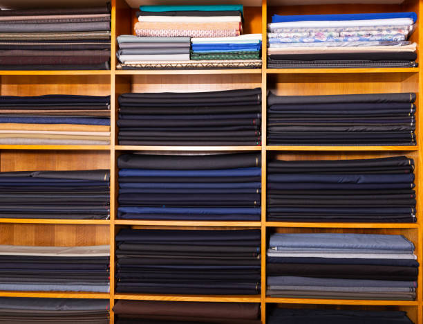 istock Rolls of fabric on shelves in shop 1184233802