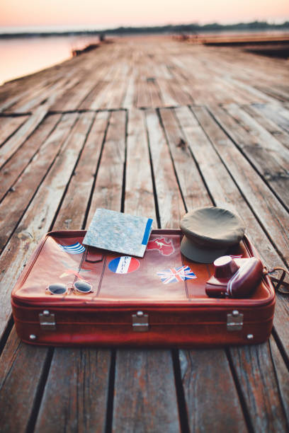 istock Tourist's stuff on lake pier 1184234290