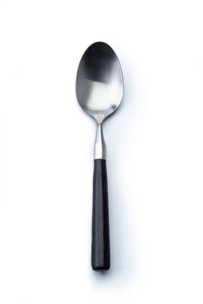 Single spoon on a white background stock photo