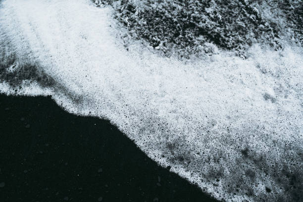 istock White ocean water and black sand beach in Iceland 1184236774