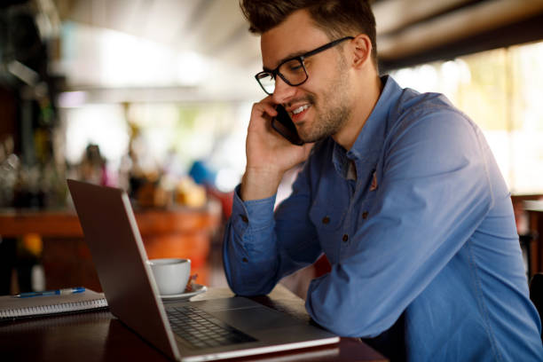 istock Young man working in coffee shop 1184238950