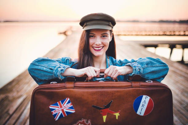 istock Traveler holding retro suitcase 1184238980