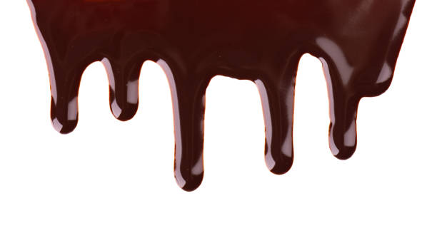 istock Chocolate streams isolated on white background. Chocolate syrup, topping, dark chocolate. 1184239012