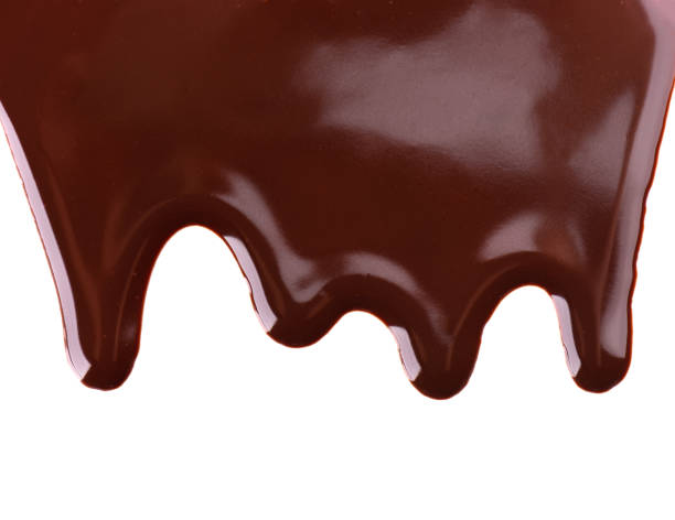 istock Chocolate streams isolated on white background. Chocolate syrup, topping, dark chocolate. 1184239177