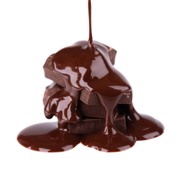 istock Chocolate pieces stack and chocolate syrup isolated on white background. Close up. 1184239300