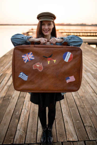 istock Tourist standing and holding suitcase 1184240588