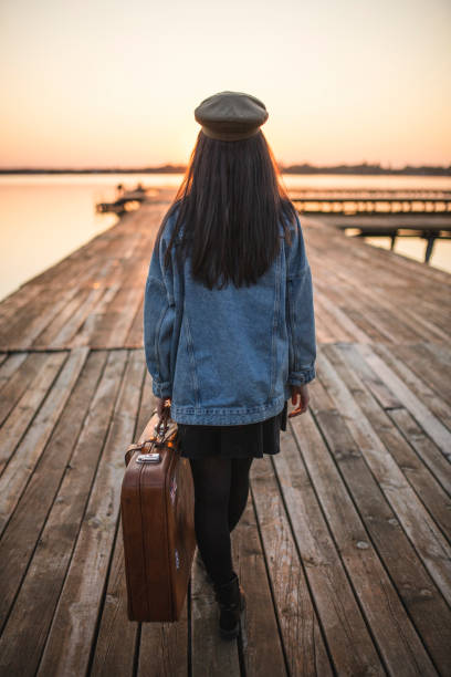 istock Back of passenger on lake pier 1184240744