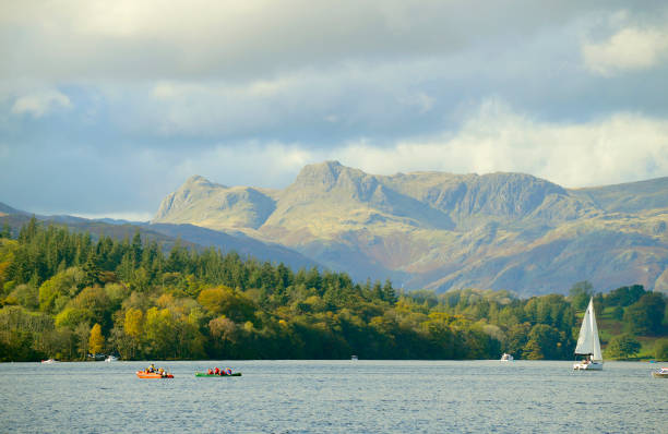 Lake Windermere with Langdale pikes in the background Lake Windermere the largest natural lake in England at the West of of the Lake in Cumbria with Langdale pikes in the background langdale pikes stock pictures, royalty-free photos & images