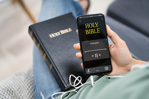 Woman Listening To Bible Audiobook On Smartphone