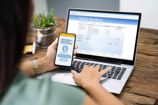 istock Woman Using Mobile Phone App To Authenthificate Bank Transfer 1184243134