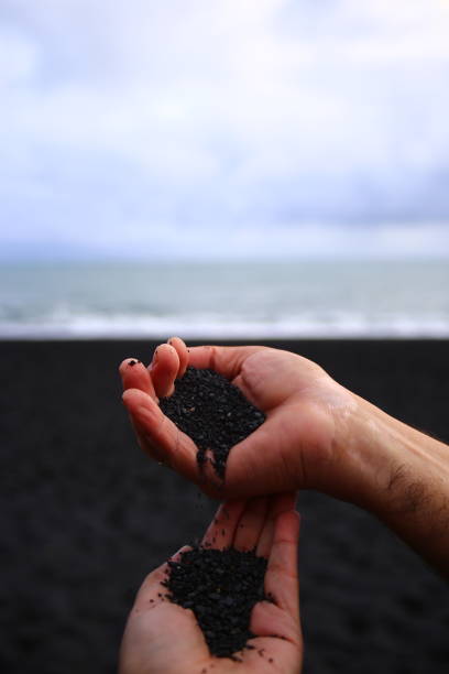 istock pair of hands dropping sand 1184243252
