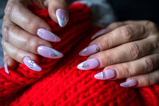 istock Women's hands with manicured nails holds woolen cloth 1184245706