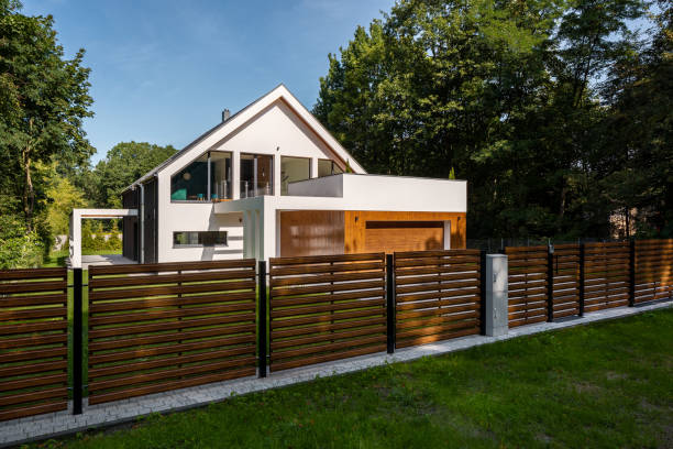 Spacious house with garage Spacious white house with wooden decoration on garage and wood style fence partition stock pictures, royalty-free photos & images