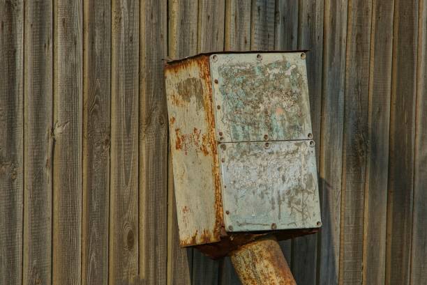 one gray metal  box against a wooden wall