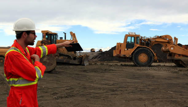 istock Male Construction worker pointing with tablet in hand at work site 1184247206