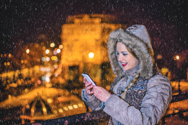 istock Woman using mobile phone on the winter night 1184250709