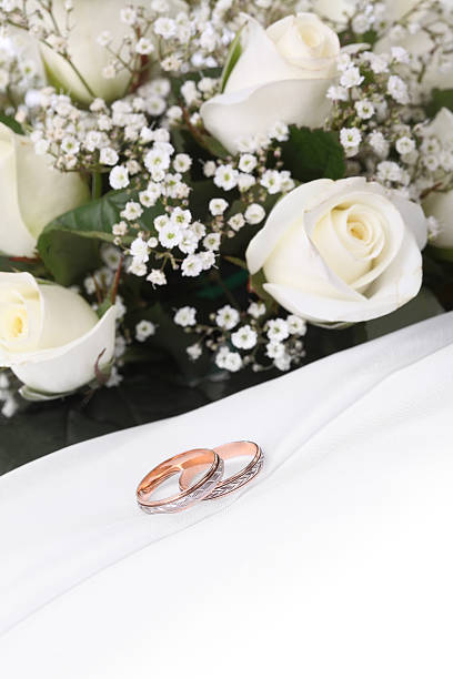 istock wedding rings and roses bouquet 118425276