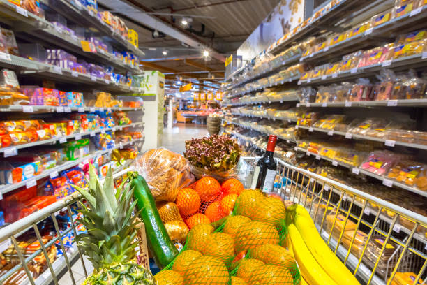 grocery cart in supermarket - carregamento imagens e fotografias de stock