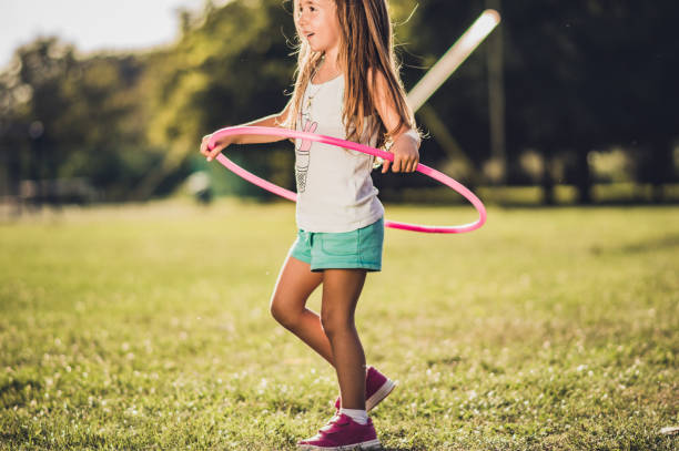 istock Beautiful girl with hula hoop 1184255998