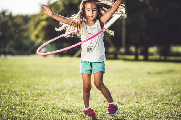 istock Beautiful girl with hula hoop 1184258715