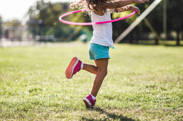 istock Beautiful girl with hula hoop 1184258790
