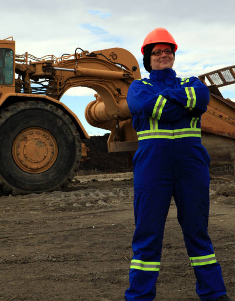istock Female Construction worker with arms crossed at work site 1184260693
