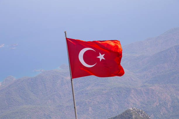 istock Low angle view of waving Turkish flag against clear sky during daytime 1184261004