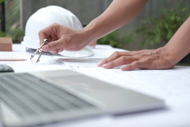 istock architect engineer working on house blueprint of real estate project. building construction concept 1184268616