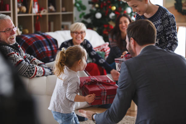 istock Father giving his children presents 1184268944