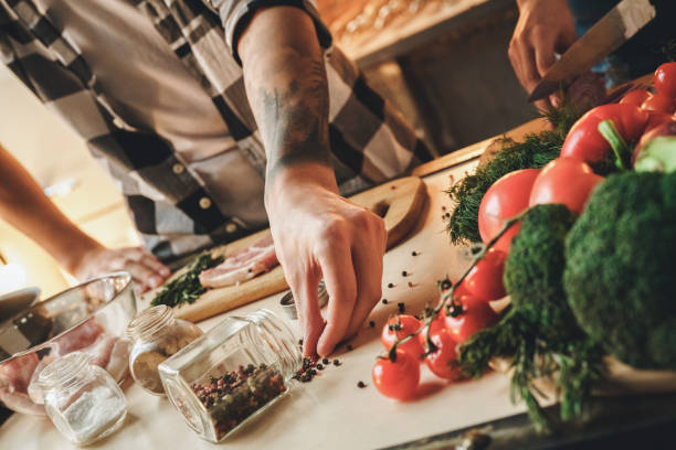 Close up detail. Unknown man cooks meat, marinades in spices
