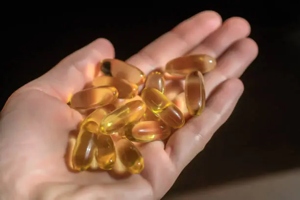 Close up capsules of fish fat oil , omega 3, vitamin Healthy food diet. Nutritional supplement