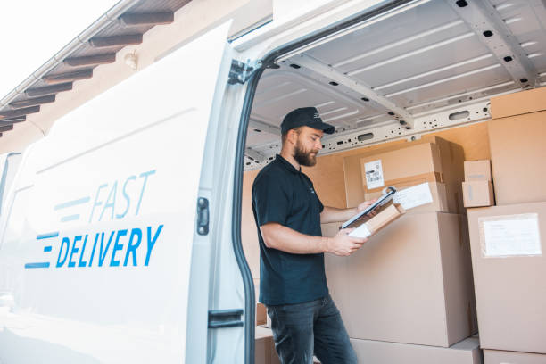 istock Mature Caucasian man checking the labels inside the delivery van 1184269437