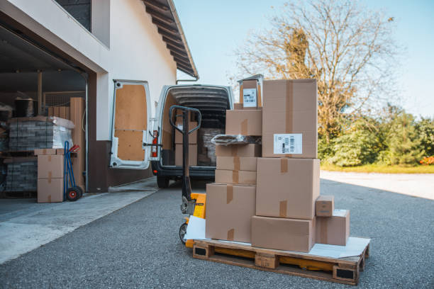 Packages on a forklift in front of the delivery van Packages on a forklift in front of the delivery van moving van stock pictures, royalty-free photos & images
