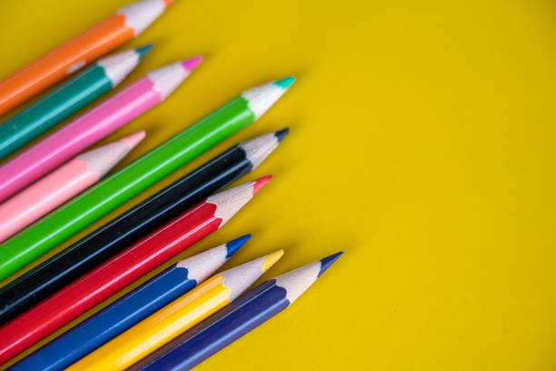 istock Colorful drawing pencils on yellow background 1184270076