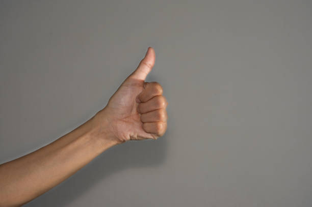 istock Woman hand with thumps up. 1184270399