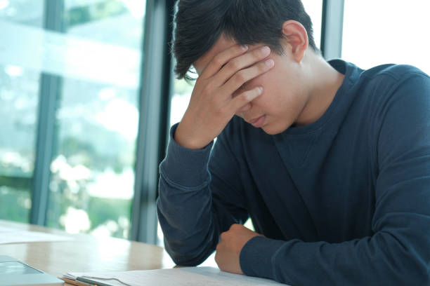 istock man feeling tired, frustrated stressed from hard work. exhausted freelancer have headache 1184275255