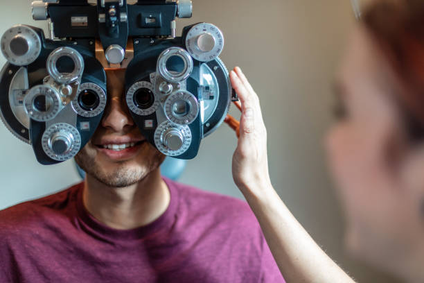 istock Eyecare Professional using high tech equipment in eyecare clinic setting part of series with millennial male and female patient in Western Colorado 1184276208