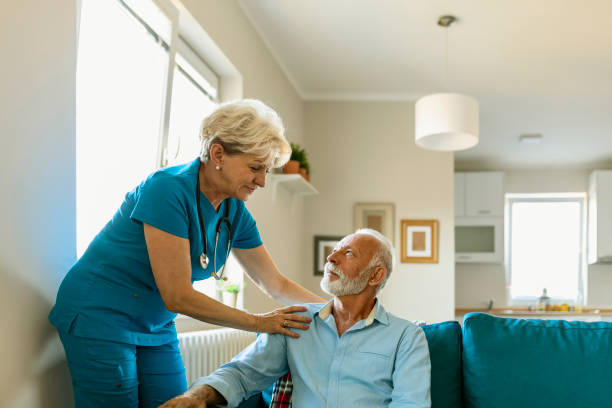istock Social worker is visiting a senior man 1184277193