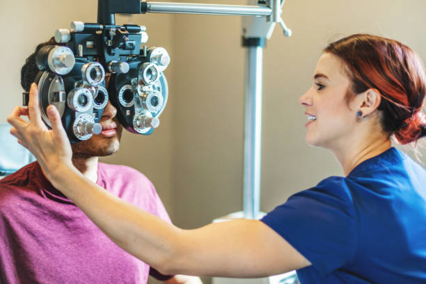 istock Eyecare Professional using high tech equipment in eyecare clinic setting part of series with millennial male and female patient in Western Colorado 1184277791