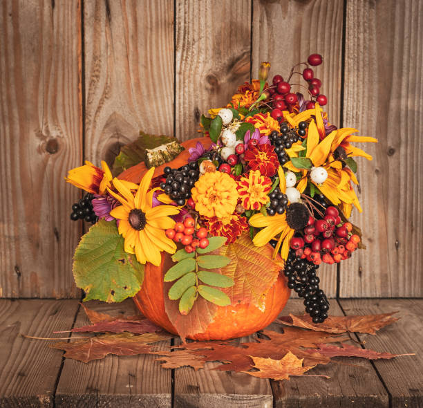 istock Flowers Bouquet in a Pumpkin Vase. 1184278865