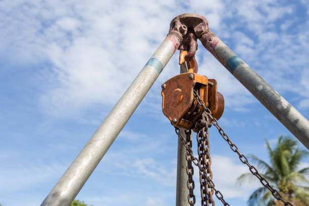 Chain hoist used in construction on blue sky background Chain hoist used in construction on blue sky background winch cable stock pictures, royalty-free photos & images