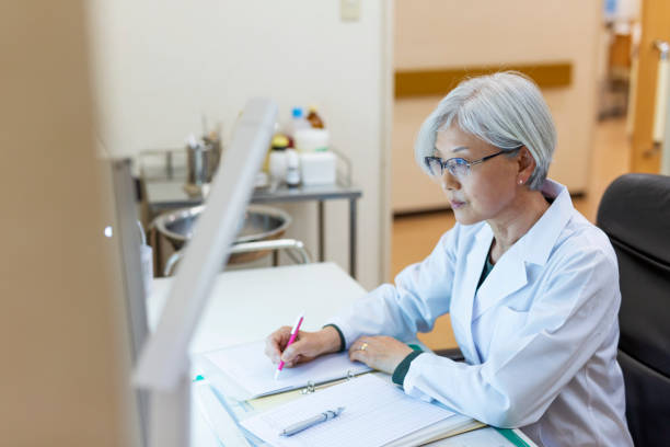 istock Senior Female Doctor Looking at Xrays in Her Office 1184282753