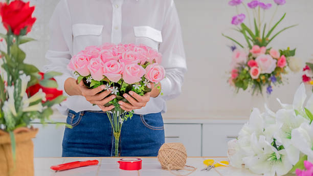 istock Woman hands making flower composition at florist workshop. Do it yourself concept. 1184282901
