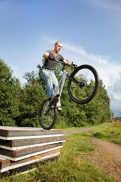 istock Freestyle young maledoing wheelie on concrete blocks. 118428443